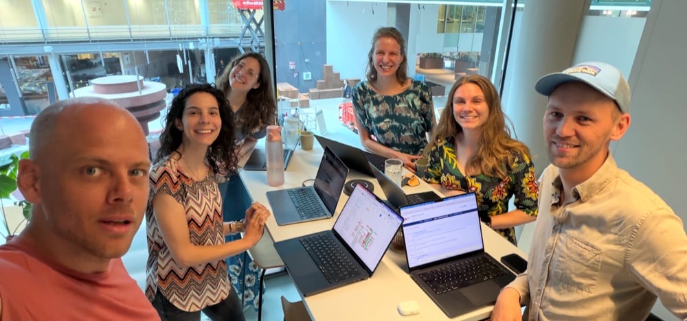 Ruben, Leonor, Catarina, Eva van der Veer, Eva Schulze and Daan around a table of laptops at our first in-person weekly meeting.